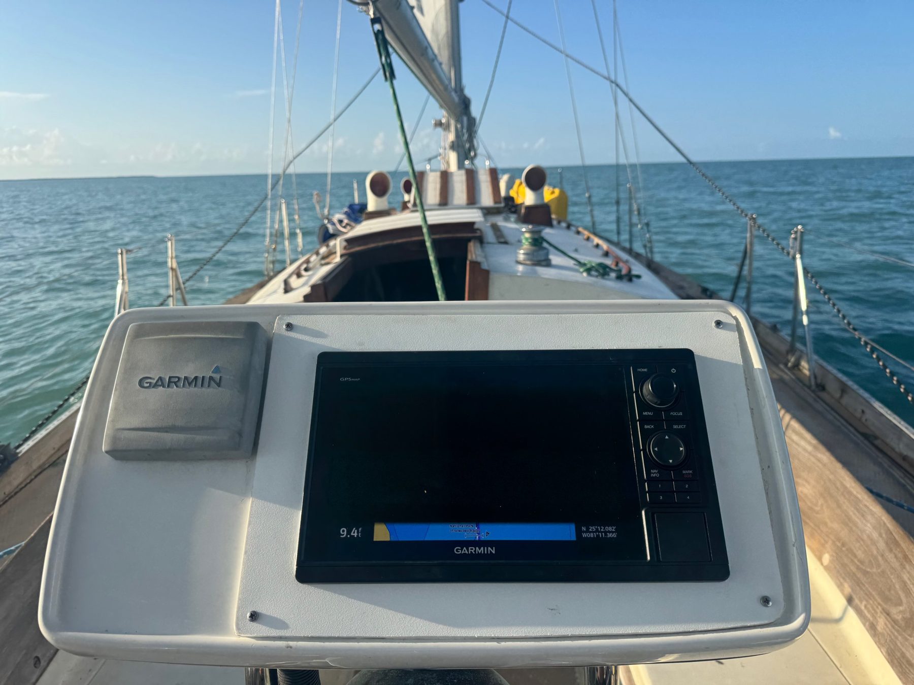 Garmin chartplotter at the helm with the bow and open water ahead